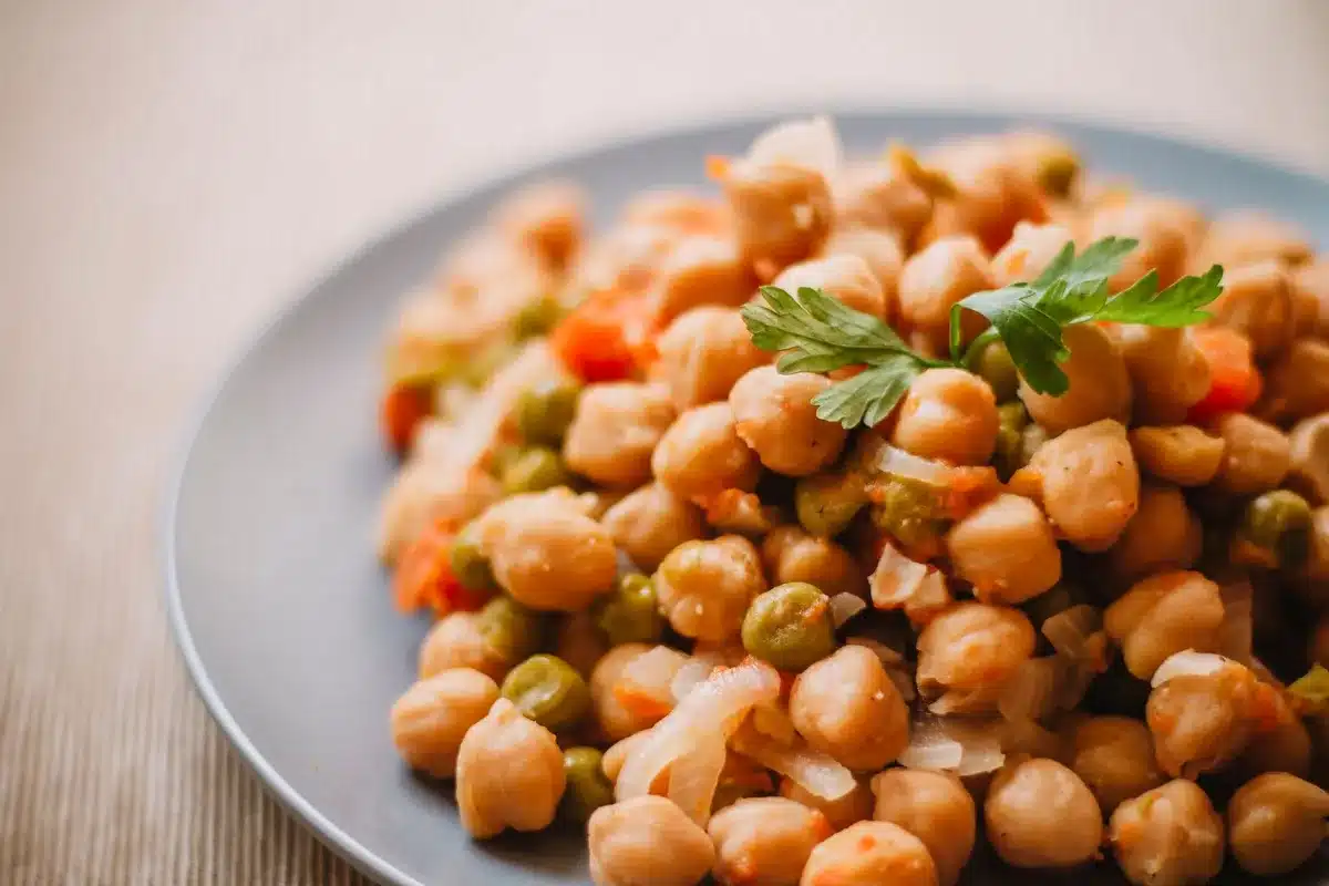 Piatto con verdure fresche, cereali integrali e legumi su tavolo luminoso